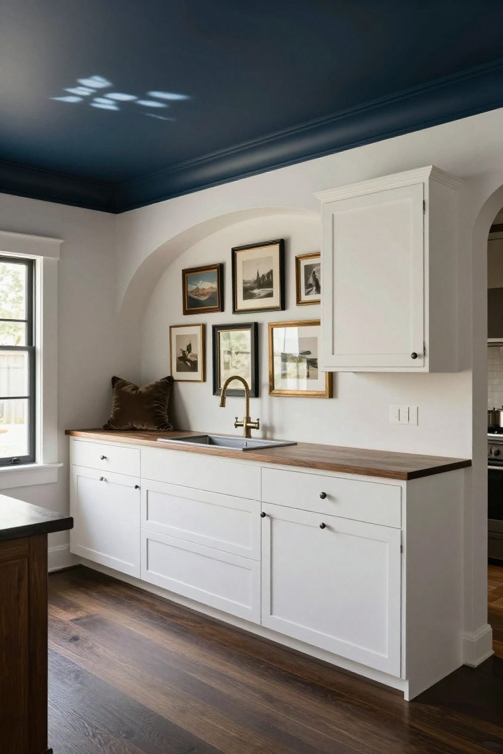 Kitchen where the wall above the cabinets is painted a deep color matching the ceiling