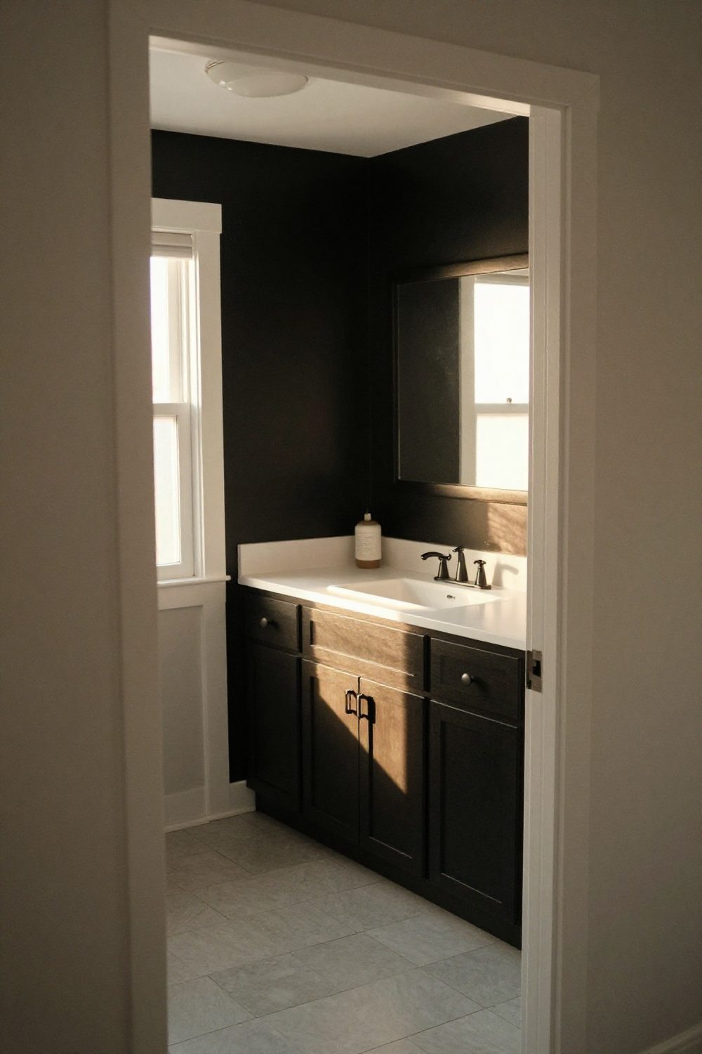 Black and white bathroom with black accent wall behind the vanity