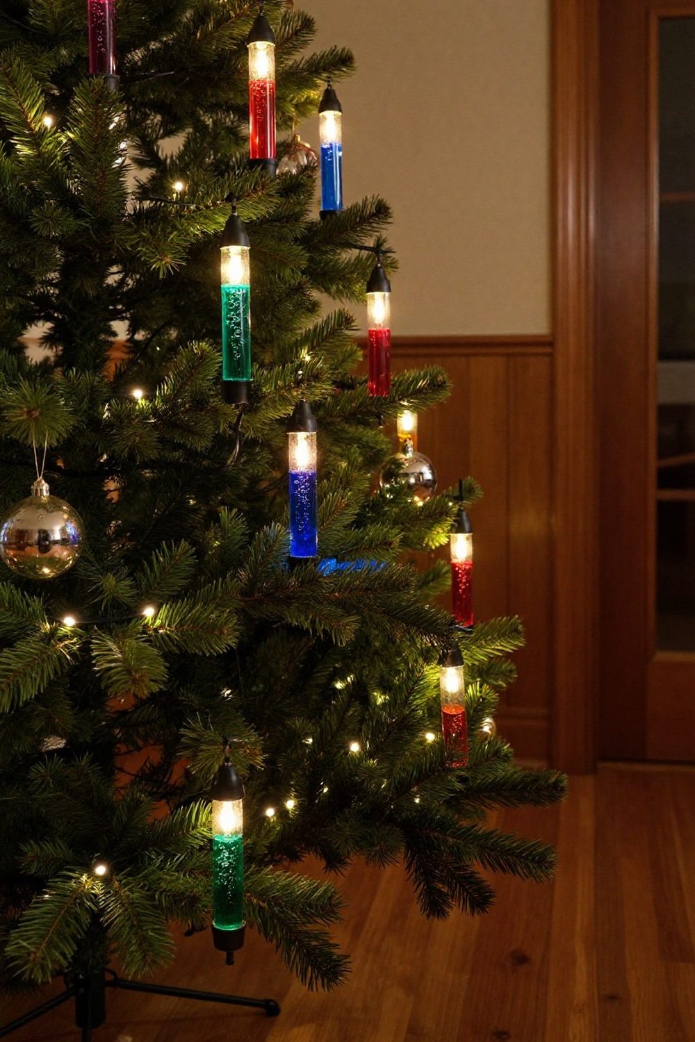 Vintage-style bubble lights glowing on the branches of a Christmas tree